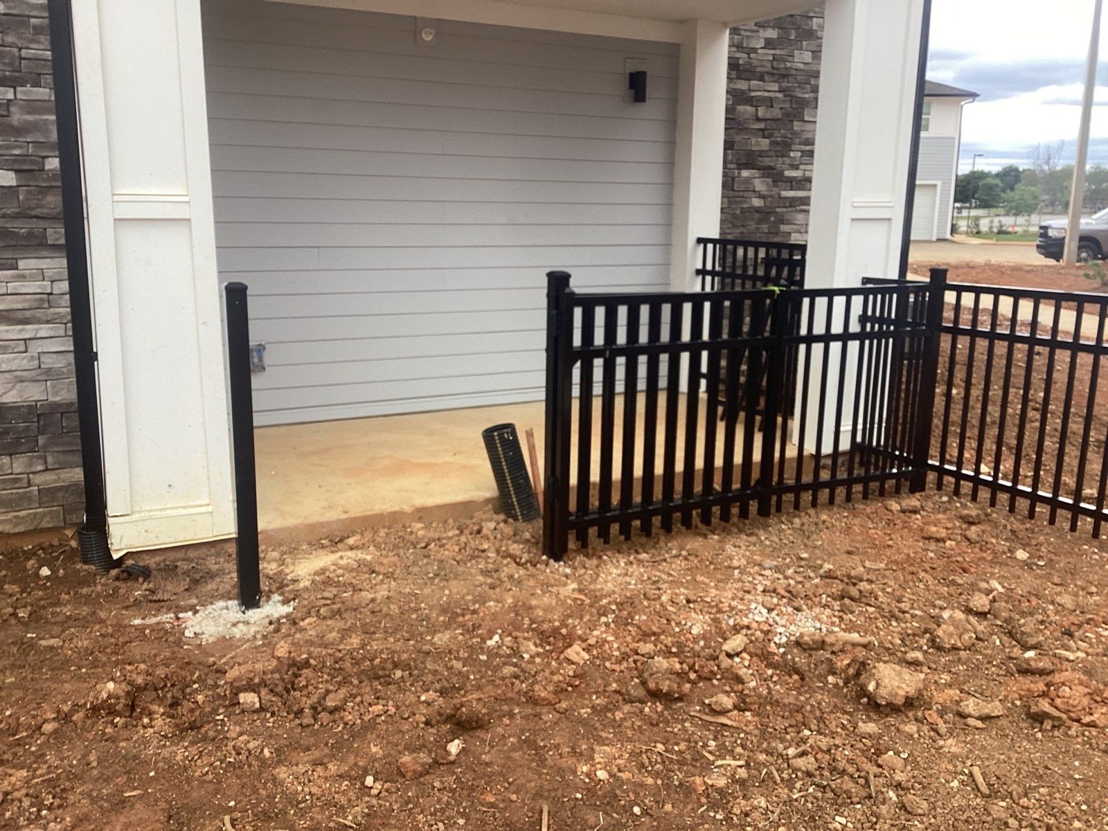 Black aluminum fence around a patio