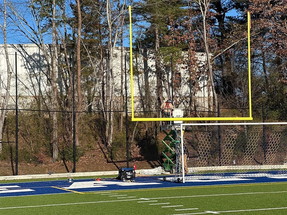 Fencing behind a football field goal post