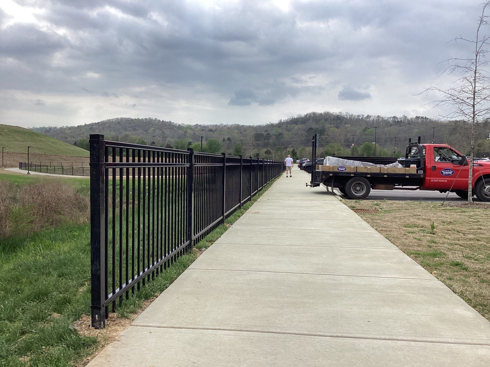 Black ornamental fence along a sidewalk